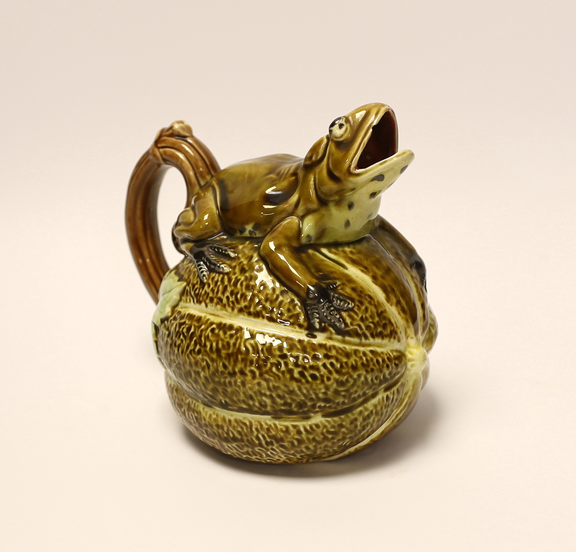 A majolica jug in the form of a frog, sitting on a melon, 17cm high